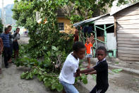 <p>Children remove fallen tree branches in the aftermath of Hurricane Irma in Puerto Plata, Dominican Republic, Sept. 8, 2017. (Photo: Ricardo Rojas/Reuters) </p>