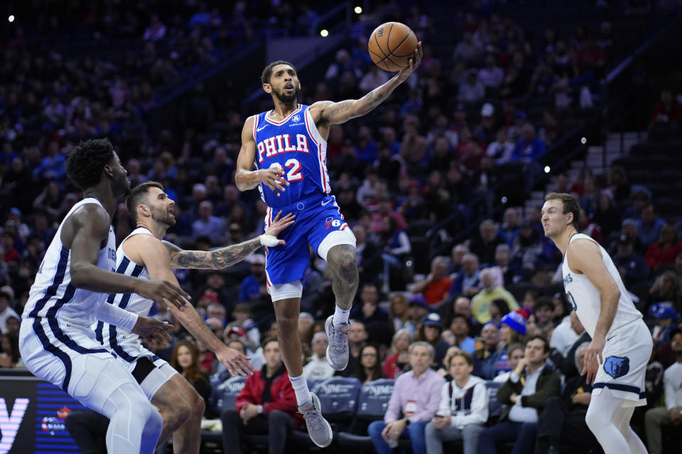 Philadelphia 76ers' Cameron Payne, right, goes up for a shot against Memphis Grizzlies' John Konchar during the first half of an NBA basketball game, Wednesday, March 6, 2024, in Philadelphia. (AP Photo/Matt Slocum)