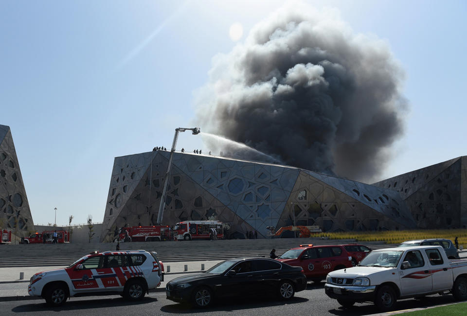 Firefighters work to contain a large fire in Kuwait City