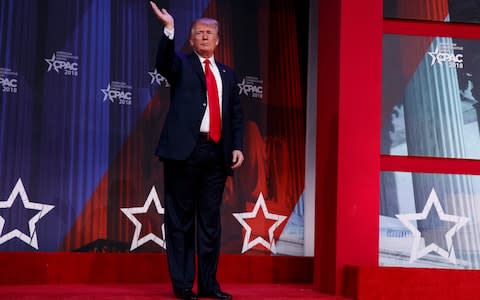 President Donald Trump waves after delivering remarks to the Conservative Political Action Conference - Credit: AP