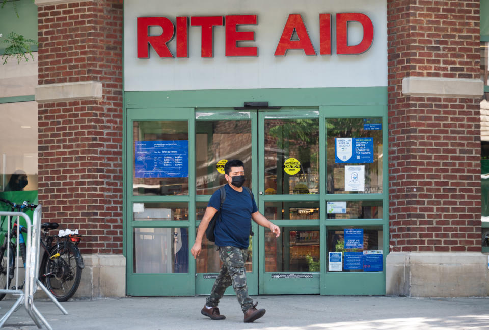 NEW YORK, NEW YORK - MAY 27: A person walks outside of Rite Aid pharmacy on May 27, 2021 in New York City. On May 19, all pandemic restrictions, including mask mandates, social distancing guidelines, venue capacities and restaurant curfews were lifted by New York Governor Andrew Cuomo.  (Photo by Noam Galai/Getty Images)