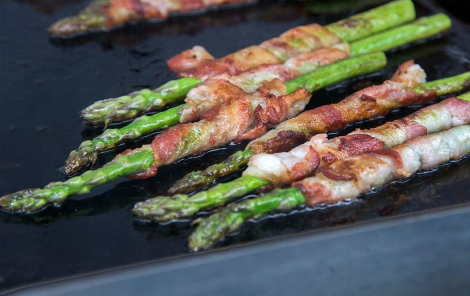 Bacon-wrapped asparagus fries on a griddle at the annual Asparagus Festival at the San Joaquin County Fairgrounds in Stockton in 2019.
