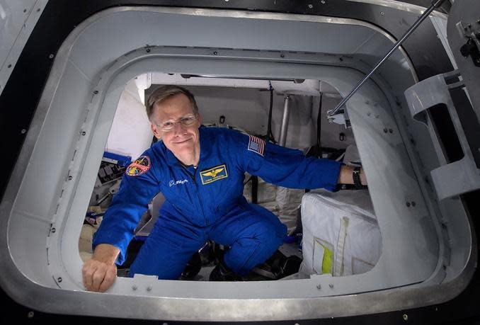 Former shuttle commander Chris Ferguson, seen in the hatch of a commercial crew ship mockup, has taken himself off Boeing's first piloted Starliner test flight, now targeted for launch next summer, to spend more time with his family. / Credit: NASA