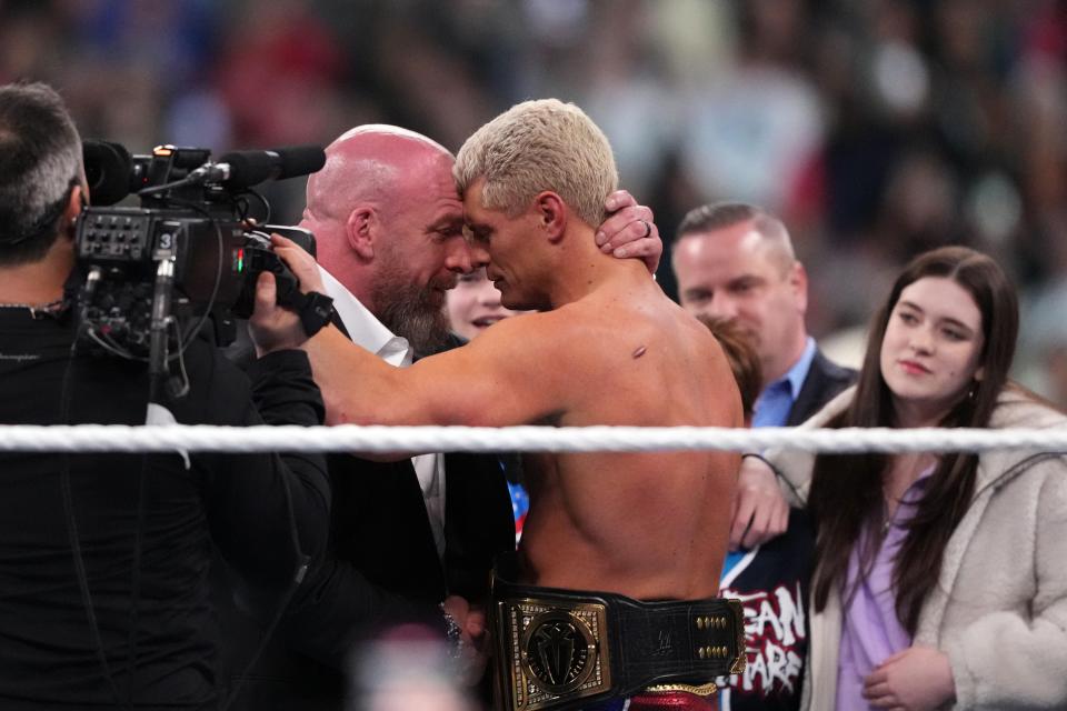 Cody Rhodes and Paul "Triple H" Levesque embrace after Rhodes won the Undisputed WWE Universal Championship during Wrestlemania XL Sunday at Lincoln Financial Field.