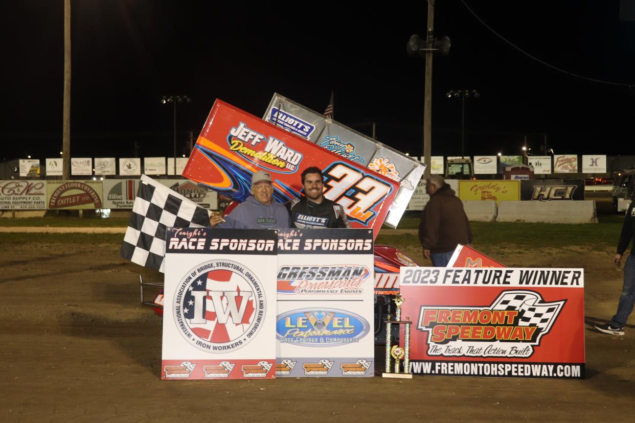 Cap Henry celebrates in Victory Lane with his car owner Jeff Ward, left, at Fremont Speedway.
