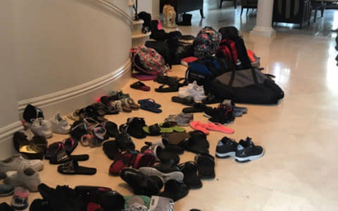 A trail of shoes leads the way into Marc Bell's home after they took in 70 foster kids  - Credit: WPEC