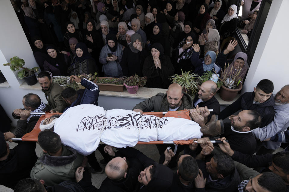 Palestinian mourners carry Mohammed Daraghmeh, 26, a co-founder of the local branch of the Islamic Jihad militant group, during his funeral in the West Bank town of Tubas, Tuesday, Feb. 27, 2024. Israeli troops shot and killed three Palestinian men including Daraghmeh, in the northern town of Tubas, early Tuesday, Palestinian health authorities said. Thee was no immediate comment from the Israeli military. (AP Photo/Majdi Mohammed)