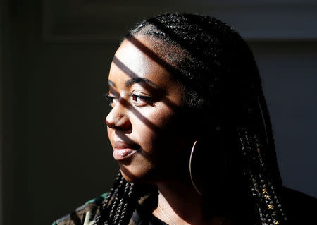 Ishea Brown, who plans to hold a Royal wedding viewing party with 19 of her friends, complete with fascinators and Hennessy, sits for a portrait at her apartment in Seattle, Washington, U.S., May 14, 2018. Picture taken May 14, 2018. REUTERS/Lindsey Wasson