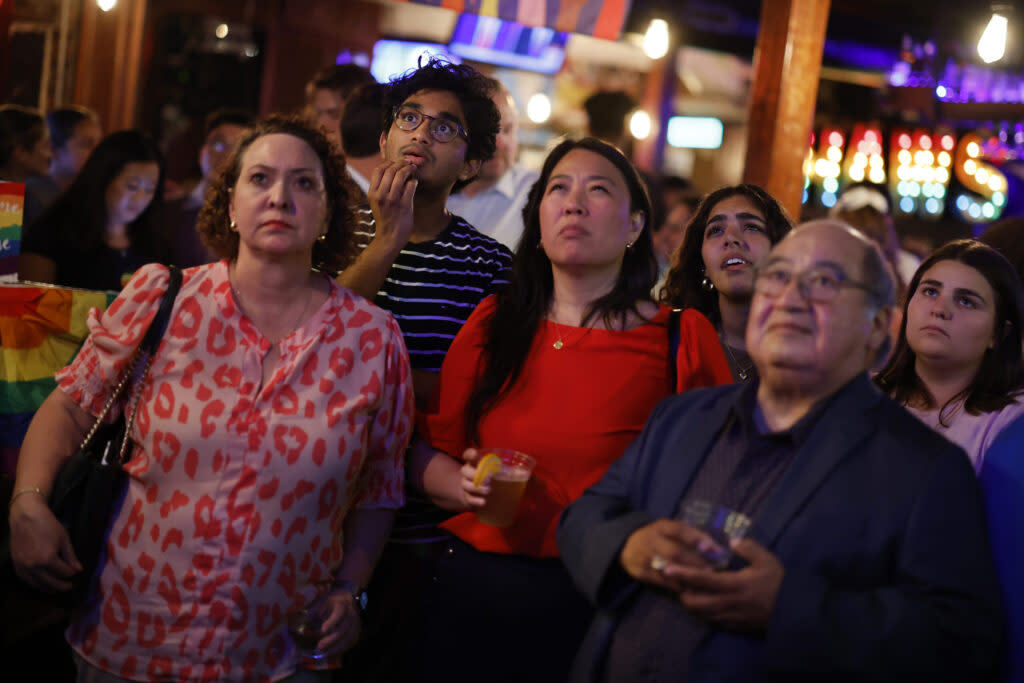 People watch the CNN presidential debate between President Joe Biden and the Republican presidential candidate, former President Donald Trump, at a debate watch party at Shaw’s Tavern on June 27, 2024 in Washington, D.C.