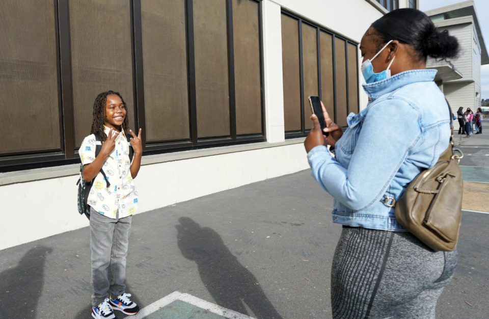 Jameela Jackson snaps a photo of her son Shadeede, a third grader, at Markham Elementary in Oakland Unified on Monday.