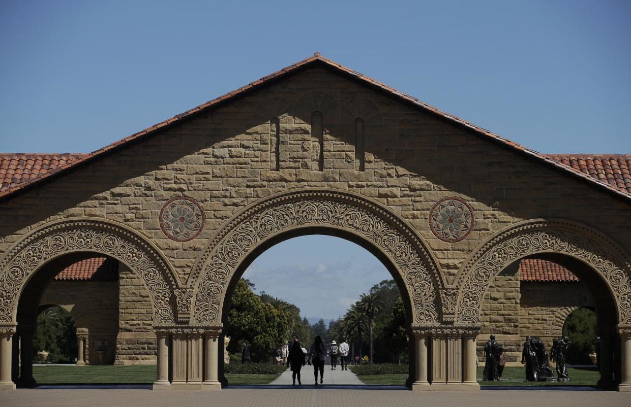 <span>Pedestrians walk on the campus at Stanford University in California in 2022.</span><span>Photograph: Jeff Chiu/AP</span>