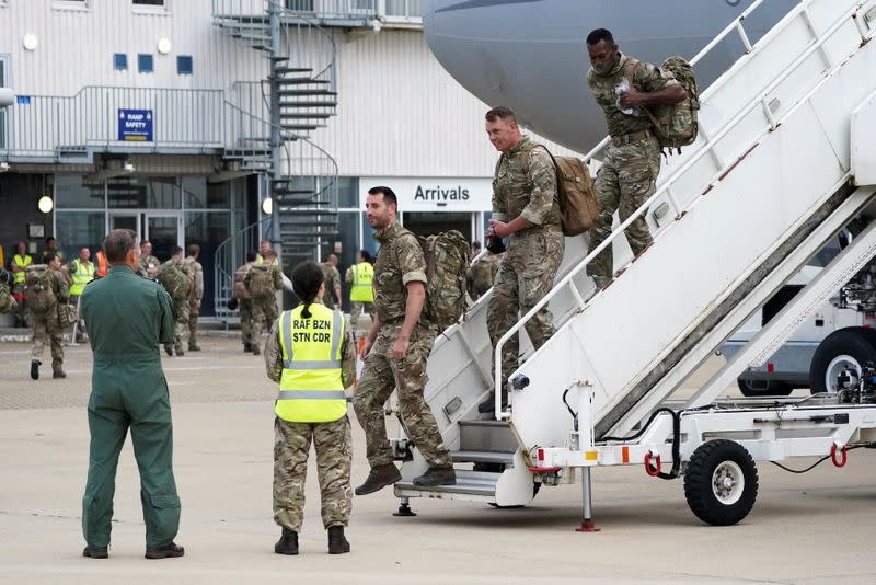Members of the British armed forces arrive at RAF Brize Norton base
