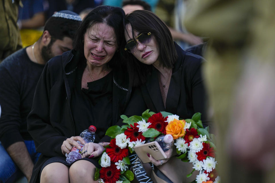 Helena Brodski cries during a memorial service for her son, Sgt. Kiril Brodski, at the Kiryat Shaul military cemetery in Tel Aviv, Wednesday, Nov. 29, 2023. Brodski and two other soldiers, believed to have been among those killed in the initial Oct. 7 Hamas attack, were declared dead by the military Tuesday, with their remains still in Gaza. (AP Photo/Ariel Schalit)