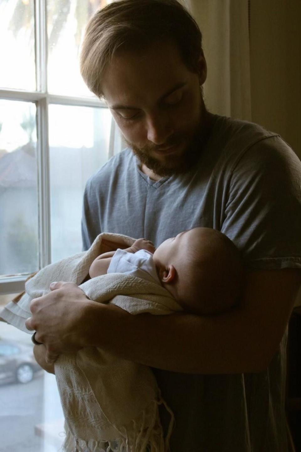 PHOTO: Trevor Melton holds his baby girl near a window. (Courtesy of Trevor and Sydney Melton)