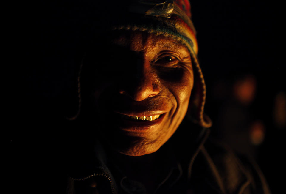 A spiritual guide known as a "Amauta," in the Indian language of Aymara, poses for a portrait during a ceremony in honor of the "Pachamama," or Mother Earth, on El Cumbre mountain, considered sacred, on the outskirts of La Paz, Bolivia, Thursday, Aug. 30, 2012. During the month of August, people gather on sacred mountains to make offerings and ask for wealth to Mother Earth.  According to local agrarian tradition, Mother Earth awakes hungry and thirsty in August and needs offerings of food and drink in order for her to be fertile and yield abundant crops. (AP Photo/Juan Karita)