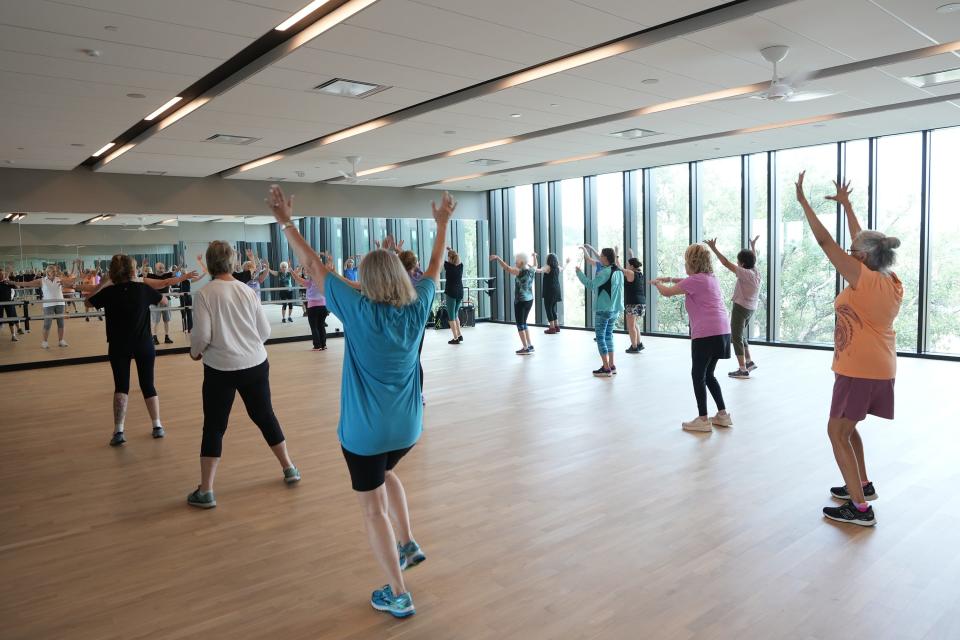 The community center houses an 11,000-square-foot health center with strength machines on the first floor and cardio studios on the second.