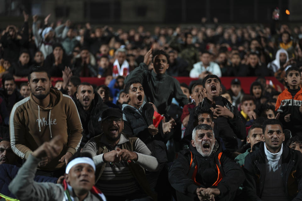 Palestinians react while watch a live broadcast of the World Cup semifinal soccer match between Morocco and France played in Qatar, at the municipality stadium in Rafah refugee camp, Southern Gaza Strip, Wednesday, Dec. 14, 2022. (AP Photo/Adel Hana)