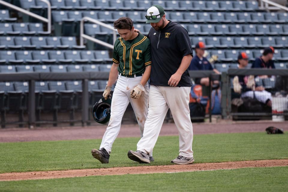 Tantasqua's Lucas MacNevin is consoled by coach Jon Leroux after the Warriors' 1-0 loss to St. Mary's.