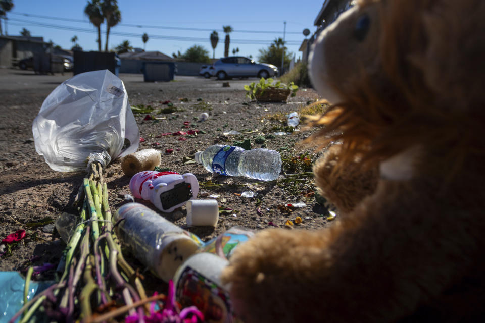 A damaged makeshift memorial for a high school student along an alleyway near Rancho High School in eastern Las Vegas on Tuesday, Nov. 21, 2023. Authorities have arrested at least eight students in connection with the beating of Jonathan Lewis Jr., who died a week after a prearranged fight over a pair of headphones and a vape pen. (AP Photo/Ty ONeil)