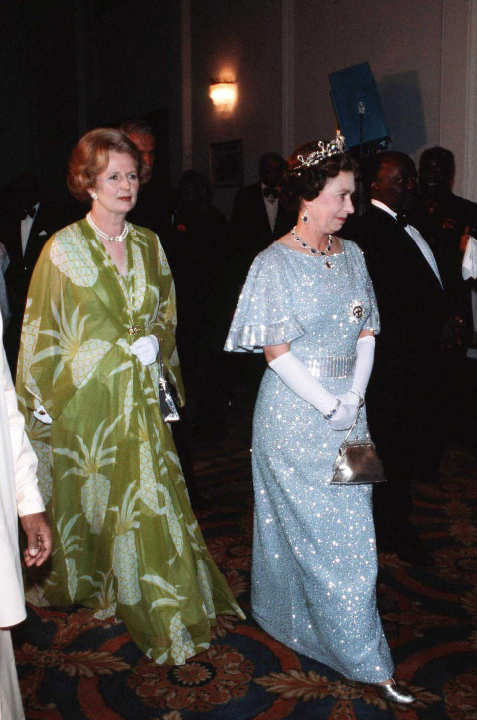 <p>Her Majesty simply dazzles in this pale blue evening dress, which she wore to a function she attended with Margaret Thatcher during the Commonwealth Heads of Government Conference. We love the metallic accessories, too. <i>[Photo: Rex]</i></p>