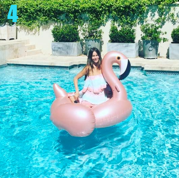 Sofia Vergara enjoys a photo op on her flamingo float, but blinks.