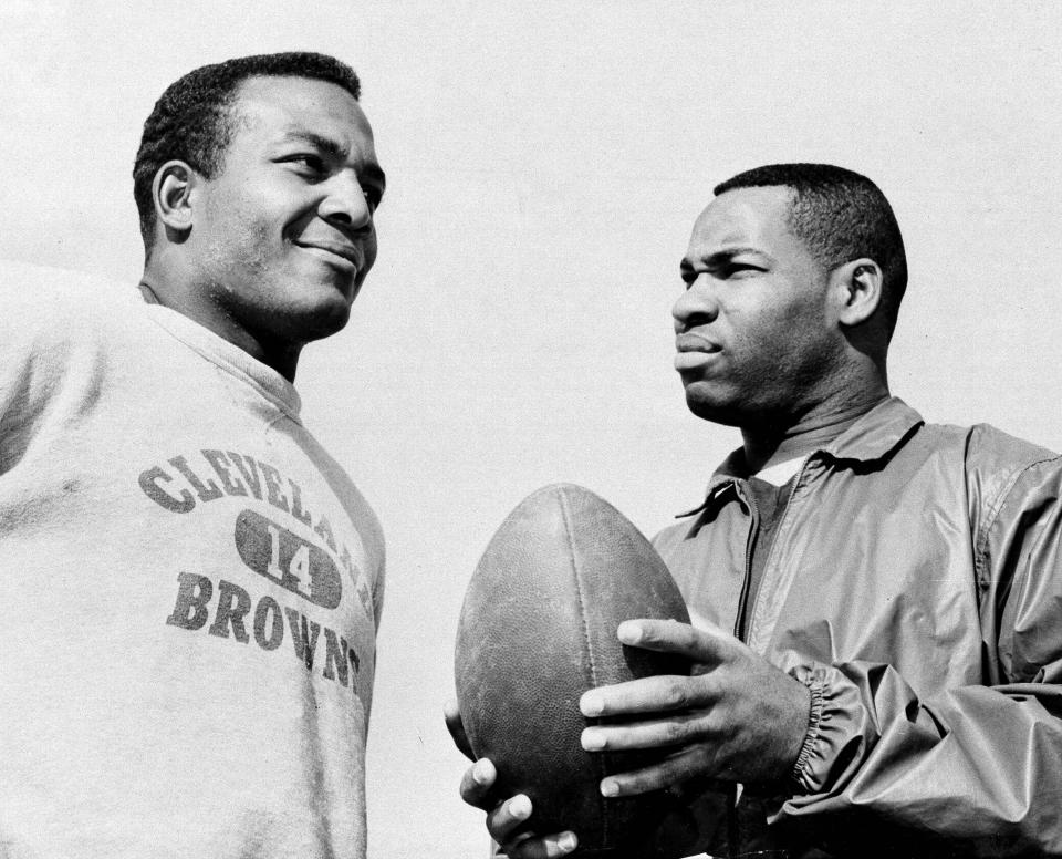 FILE - In this Jan. 11, 1964, file photo, fullback Jim Brown, left, and flanker back Bobby Mitchell, once a feared duo for the Cleveland Browns before Mitchell was dealt to Washington, are back together as teammates, as they prepare for the annual Pro Bowl at Los Angeles. Mitchell, the speedy late 1950s and ’60s NFL offensive star the Browns and the Washington Redskins, has died. He was 84. The Pro Football Hall of Fame said Sunday night, April 5, 2020, that Mitchell’s family said he died in the afternoon. (AP Photo/Harold Filan, File)