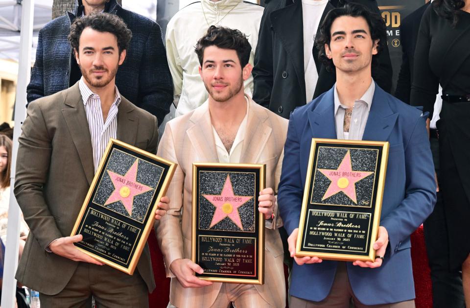 The Jonas Brothers, from L to R, Kevin Jonas, Nick Jonas and Joe Jonas, pose at their Hollywood Walk of Fame Star ceremony on Jan. 30, 2023, in Hollywood, California.