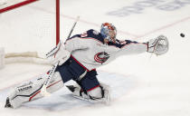 Columbus Blue Jackets goaltender Daniil Tarasov stretches for the puck during the third period of the team's NHL hockey game against the Montreal Canadiens on Tuesday, March 12, 2024, in Montreal. (Christinne Muschi/The Canadian Press via AP)