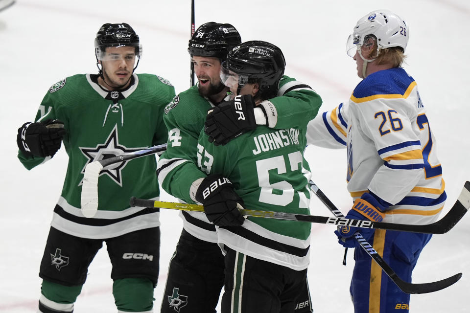 Buffalo Sabres defenseman Rasmus Dahlin (26) skates away as Dallas Stars center Wyatt Johnston (53) celebrates his goal with teammates Jamie Benn (14) and Logan Stankoven (11) during the second period an NHL hockey game in Dallas, Tuesday, April 9, 2024. (AP Photo/LM Otero)