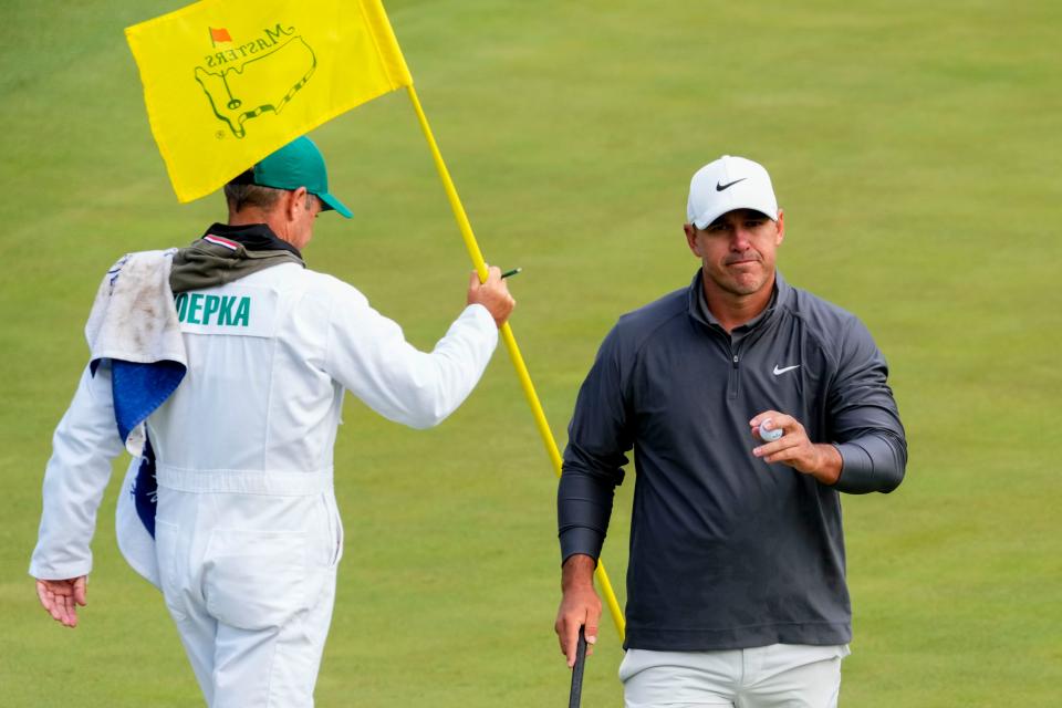 Brooks Koepka walks off the 15th green after making his par putt during Sunday's completion of the third round of the Masters.
