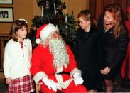 <p>Sarah, Duchess of York watches daughters Princess Beatrice and Princess Eugenie as they talk to Santa at the National Society for the Prevention of Cruelty to Children party.</p>