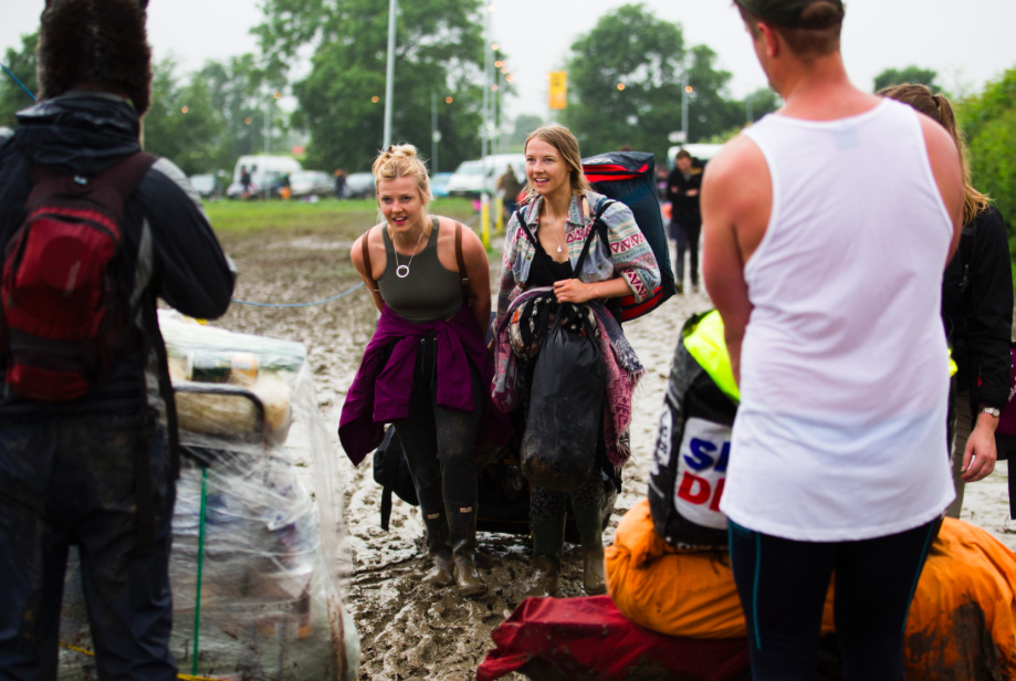 It may be muddy but these ladies are smiling through it like true Brits. (SWNS)