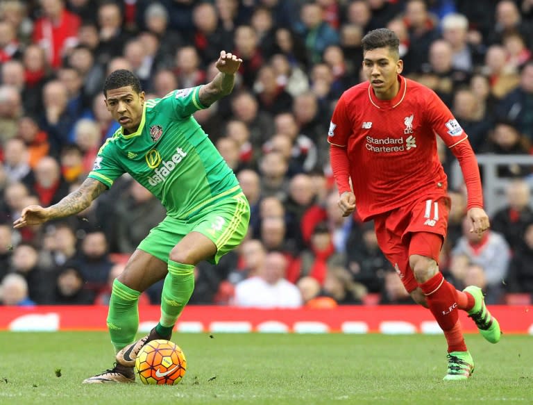 Liverpool's striker Roberto Firmino (R) vies with Sunderland's defender Patrick van Aanholt during the English Premier League football match at Anfield in Liverpool, England, on February 6, 2016