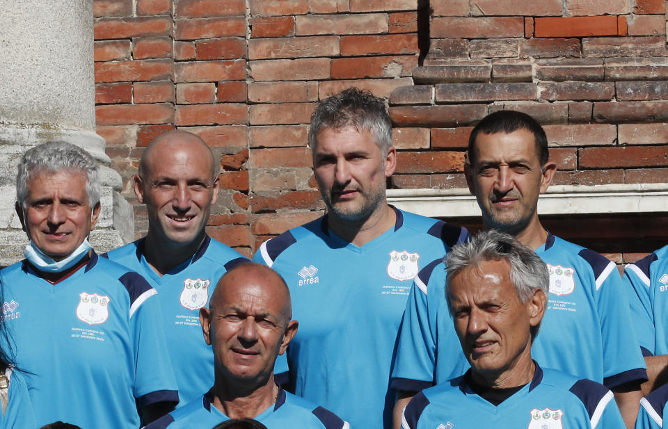 Mattia Maestri, top row, third from left, poses for a group photo prior to the start of a 180-kilometer relay race, in Codogno, Italy, Saturday, Sept. 26, 2020. Italy’s coronavirus Patient No. 1, whose case confirmed one of the world’s deadliest outbreaks was underway, is taking part in a 180-kilometer relay race as a sign of hope for COVID victims after he himself recovered from weeks in intensive care. Mattia Maestri, a 38-year-old Unilever manager, was suited up Saturday for the start of the two-day race between Italy’s first two virus hotspots. It began in Codogno, where Maestri tested positive Feb. 21, and was ending Sunday in Vo’Euganeo, where Italy’s first official COVID death was recorded the same day. (AP Photo/Antonio Calanni)