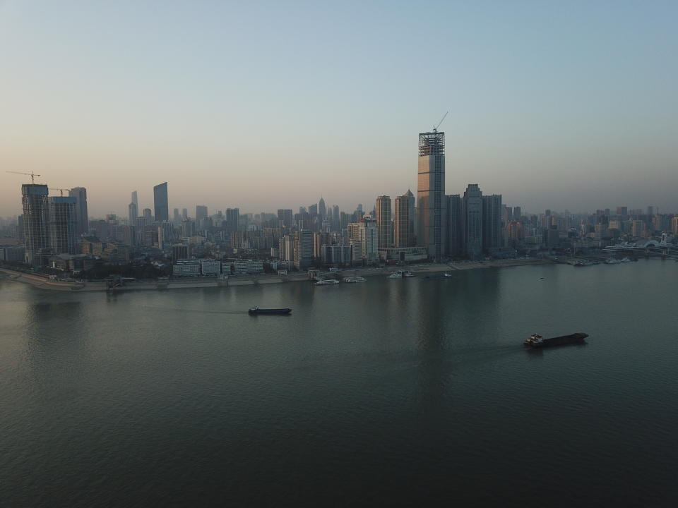 This aerial photo shows Wuhan skyline, China, Thursday evening, Jan. 14, 2021. A global team of researchers arrived Thursday in the Chinese city where the coronavirus pandemic was first detected to conduct a politically sensitive investigation into its origins amid uncertainty about whether Beijing might try to prevent embarrassing discoveries. (AP Photo/Samuel McNeil)