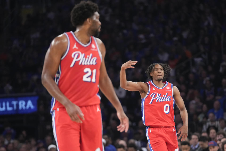 Philadelphia 76ers guard Tyrese Maxey (0) and center Joel Embiid react after Maxey scored a 3-point basket during the first half in Game 1 of an NBA basketball first-round playoff series against the New York Knicks, Saturday, April 20, 2024, at Madison Square Garden in New York. (AP Photo/Mary Altaffer)