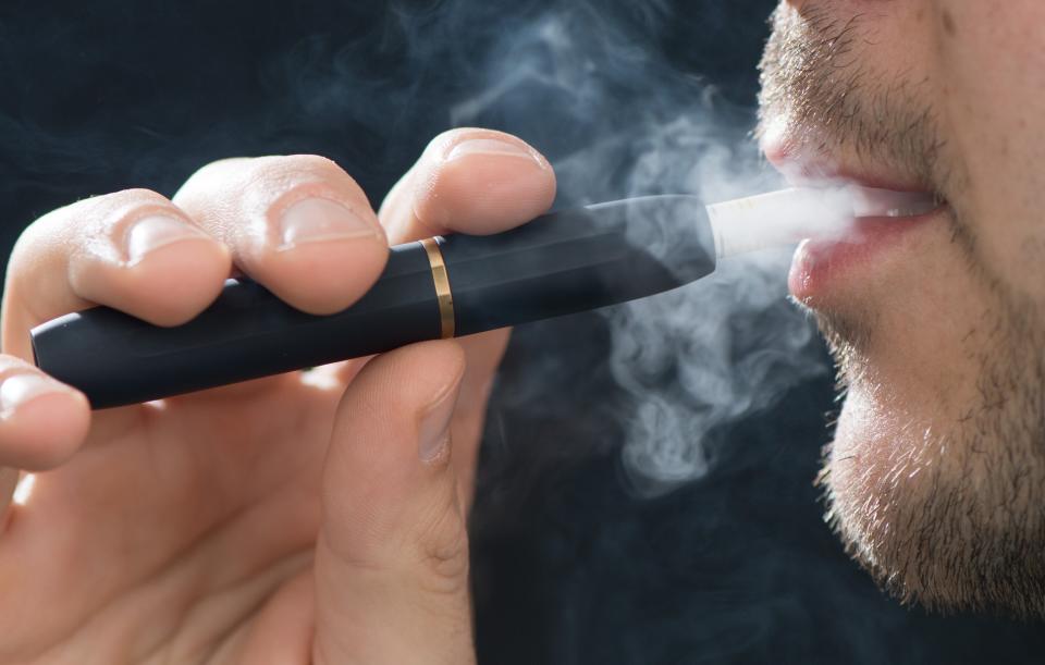 A man uses an IQOS, a heated tobacco device made by Philip Morris International. (Photo: picture alliance via Getty Images)