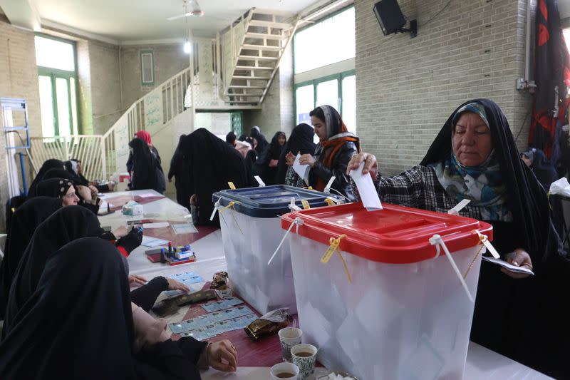 Iranians vote during parliamentary elections at a polling station in Tehran