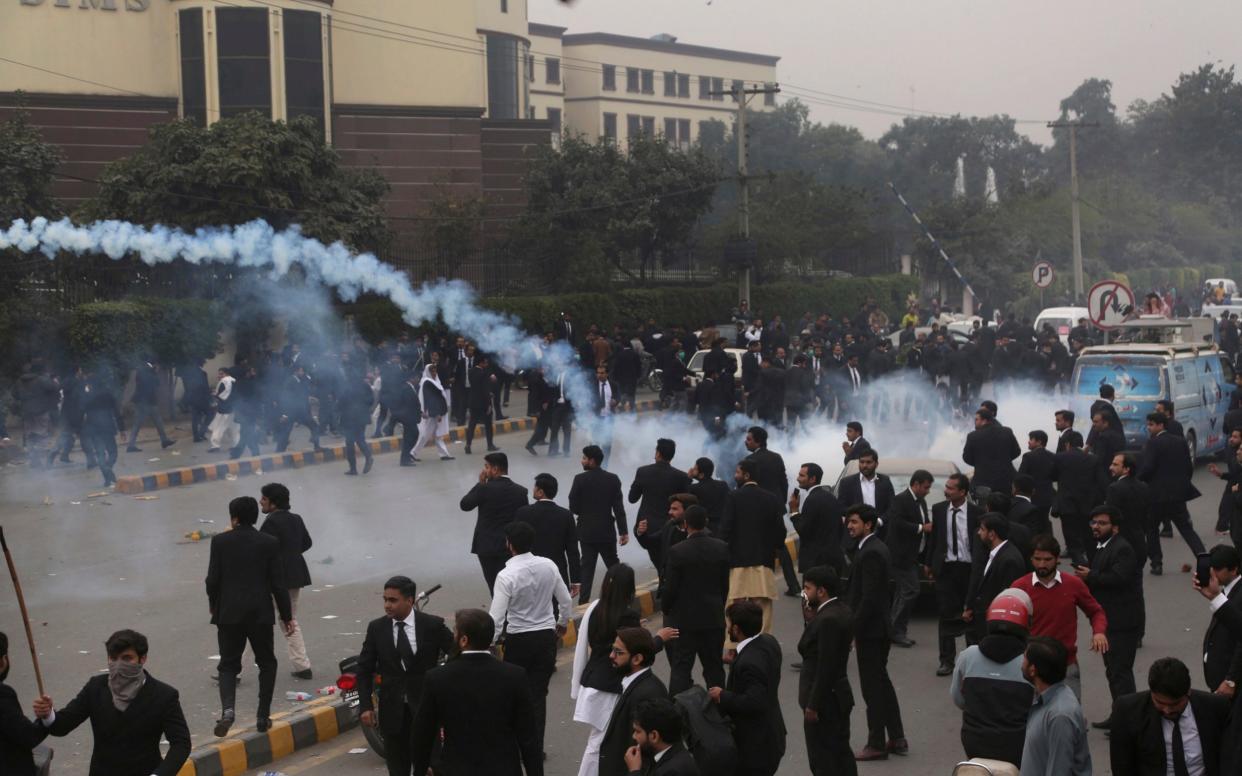 Police use tear gas to disperse angry lawyers  during the clash in Lahore, Pakistan, - AP