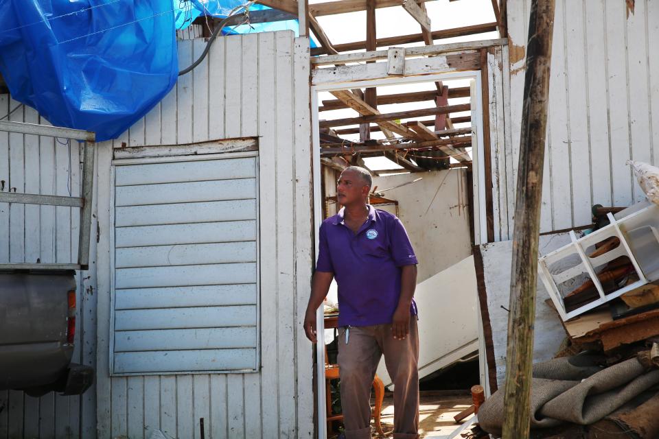 Three weeks after the storm, Danny Guerrero Herrera stands at the door of his home, which was largely destroyed by Hurricane Maria. (Photo: Carolina Moreno/HuffPost)