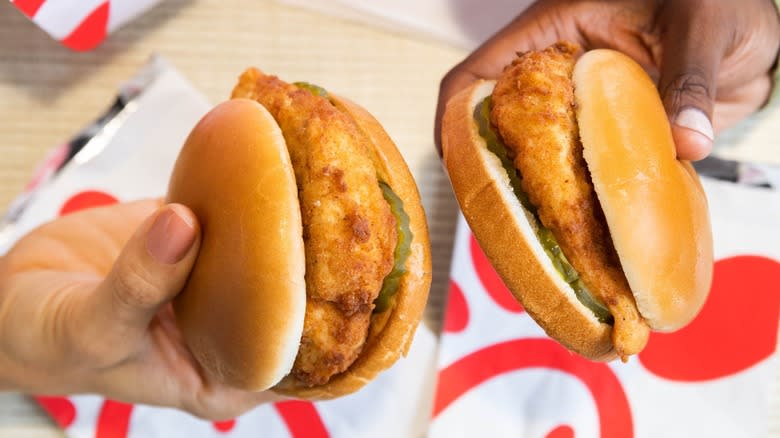 Two Hands Holding Chick-fil-A Sandwiches