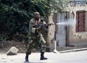 A soldier fires an AK-47 rifle during a protest against President Pierre Nkurunziza and his bid for a third term, in Bujumbura, Burundi, May 25, 2015. REUTERS/Goran Tomasevic