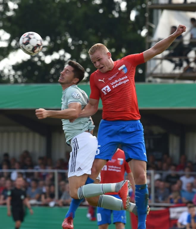 Bayern Munich scorer Robert Lewandowski vies for the ball with Drochtersen's Alexander Rogowski