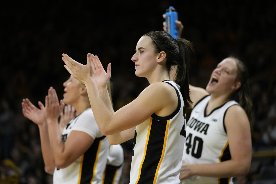 Iowa guard Caitlin Clark, center, celebrates during the second half of an NCAA college basketball game against Drake, Sunday, Nov. 19, 2023, in Iowa City, Iowa. Iowa won 113-90. (AP Photo/Charlie Neibergall)