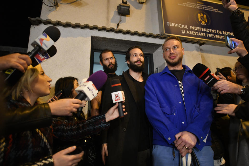 Andrew Tate, left, and his brother Tristan leave a police detention facility in Bucharest, Romania, after his release from prison on Friday March 31, 2023. An official on Friday said Tate, the divisive internet personality who has spent months in a Romanian jail on suspicion of organized crime and human trafficking, has won an appeal to replace his detention with house arrest. (AP Photo/Alexandru Dobre)