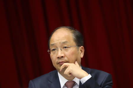 FILE PHOTO: Yi Huiman, chairman of China Securities Regulatory Commission (CSRC), attends a meeting of Fujian delegation on the sidelines of the National People's Congress (NPC), at the Great Hall of the People in Beijing, China March 5, 2019. REUTERS/Stringer