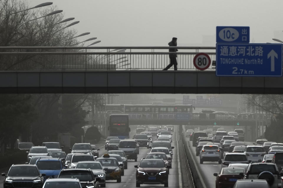 Vehicles move on a city highway in Beijing, Monday, Dec. 12, 2022, as capital city is hit by sandstorm. China will drop a travel tracing requirement as part of an uncertain exit from its strict "zero-COVID" policies that have elicited widespread dissatisfaction. (AP Photo/Andy Wong)