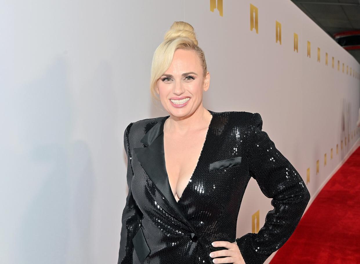 Rebel Wilson standing on red carpet