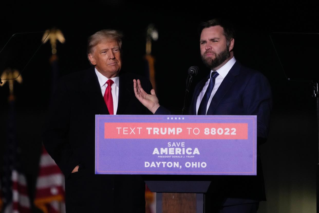 Former President Donald Trump greets U.S. Senate candidate J.D. Vance during a rally at Wright Bros. Aero Inc. at Dayton International Airport on Monday, Nov. 7, 2022, in Vandalia, Ohio.