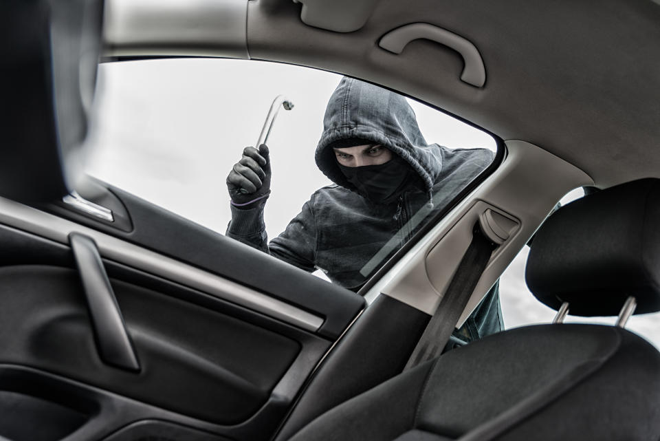 Masked thief hijacks car (Getty Creative)